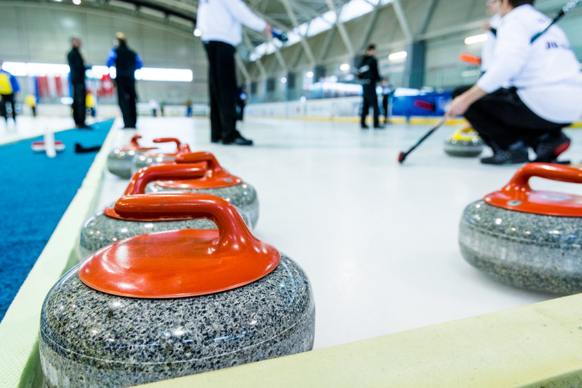 Curling stone on a game sheet. Indoor sport on ice.